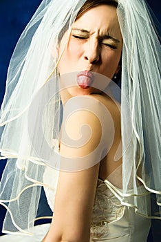 Capricious bride showing her tongue photo