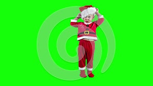 Capricious child boy take of Santa hat and throw on ground. Green chroma key