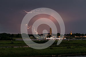 Capricious lightning strike close to the historic tower in the town of Zaltbommel, The Netherlands.