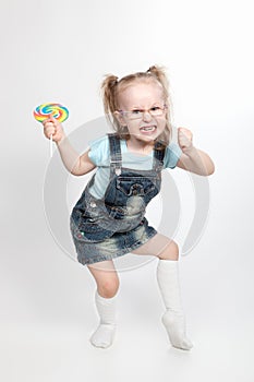 Capricious little girl with lollipop