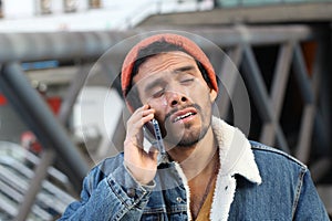 Capricious man crying on the phone