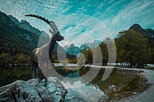 Capricorn statue at the Lake Jasna in kranjska gora in early autumn