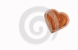 Capsicum annuum - Organic red paprika powder in heart shaped bowl