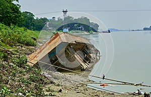 Capsized boat on a river bank