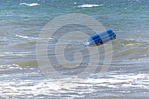 Capsized inflatable boat in the sea