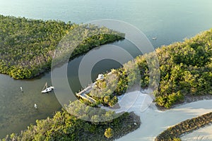 Capsized sunken sailing boat left forsaken on shallow bay waters after hurricane Ian in Manasota, Florida