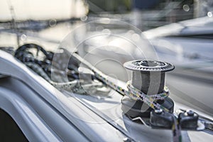 Capstan with line on a sailboat with white background.