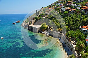 Capstone wall on the shoreline of beautiful Mediterranean sea in ancient Turkish fortress, Alanya city. Antalya, Turkey.