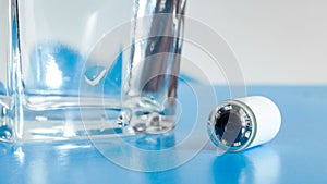 Capsule with camera for capsular endoscopy and glass of water