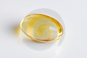 Capsule of cod-liver oil on white background