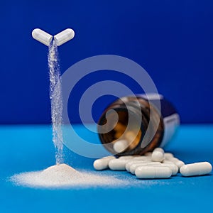 Capsule drug pouring down with a lot of white capsules