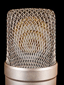 Capsule of gold condenser microphone isolated on black