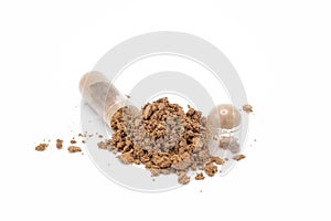 Capsule of medicine and the powder that has been poured out on white background