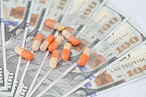 Capsule medicines on hundred-dollar bills