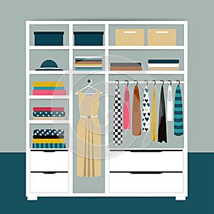 Capsule minimalistic open wardrobe. Wooden closet with tidy clothes  shirts  sweaters  boxes and shoes.