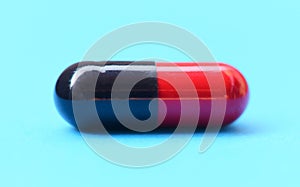 Capsule pill selective focus- Close up of color red and black medicine pills capsule drugs concept