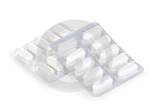 Capsule pills in blister pack close-up isolated on white background