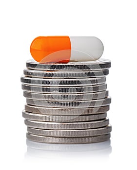 Capsule on a stack of coins isolated