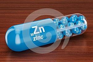 Capsule with zinc Zn element on the wooden table. 3D rendering