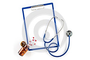 Capsules and bottle with clipboard and stethoscope cardiology