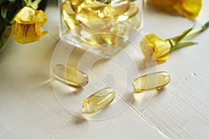 Capsules of evening primrose oil on a table - healthy nutritional supplement