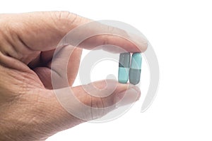 Capsules of medicine for anti biotic, blue and green capsules in my hand