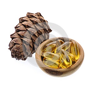 Capsules of oil turpentine with cedar cone photo