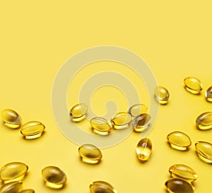 Capsules pill with vitamin D on yellow background close-up. Fish oil, Omega, Omega-3, dietary supplement, sunshine vitamin.