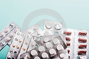 Capsules, pills in blister packs on a blue background