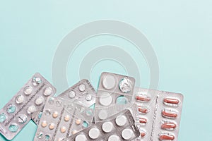 Capsules, pills in blister packs on a blue background