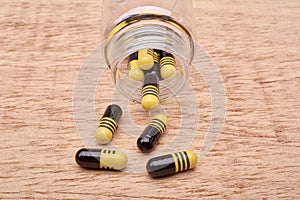 Capsules pills of medicament from transparent bottle