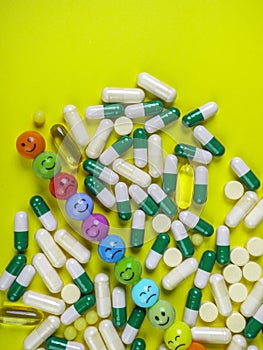 capsules pills and tablets on yellow background with funny faces