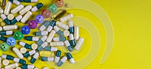 capsules pills and tablets on yellow background with funny faces