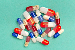 capsules & x28;pills& x29; on a turquoise background. Medical background, template