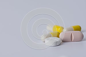 capsules and tablets oval and round on a white background