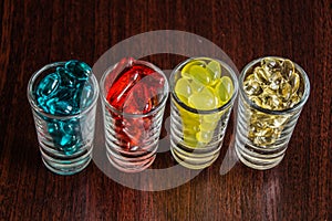 Capsules and tablets in small glasses 2