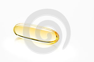 Capsules. Yellow pills isolated on white. Close up capsules with Vitamin D, E or Omega 3,6,9 fatty acids. Food supplement oil