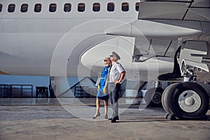 Captain with air hostess enjoying good weather in the airport