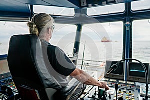 Captain of deck Officer on bridge of vessel or ship during navigaton watch at sea