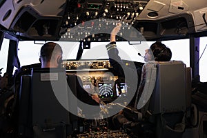 Captain and female copilot getting ready to fly plane