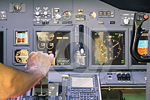 Captain hand accelerating on the throttle in flight simulator