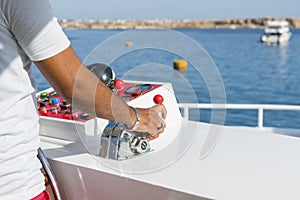 Captain at the helm yacht. Men`s hand drives a yacht. concept of sea recreation and tourism