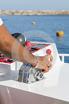 Captain at the helm yacht. Men`s hand drives a yacht. concept of sea recreation and tourism. vertical photo