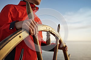 Captain Holding Hands on ship rudder