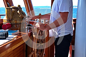 Captain holding hands on ship rudder