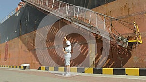 Captain looking through the binoculars near a huge vessel