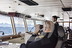 Captain of cruiser glassing out for icebergs on Arctic Ocean