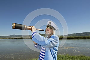 Captain looks through a telescope