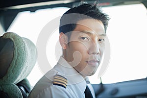 Captain male pilot portrait, driving an airplane