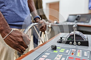 Captain`s hands at the helm of a boat.Captain`s hands at the helm of a boat.Captain`s hands at the helm of a boat